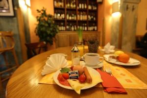 una mesa de madera con un plato de comida. en U Cervene zidle - Red Chair Hotel, en Praga
