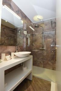 a bathroom with a sink and a shower at Relais Villa Porta in Luino