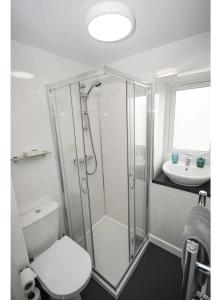a bathroom with a shower and a toilet and a sink at ALTIDO House in Camborne, Cornwall in Camborne