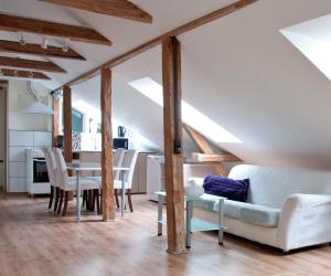 a living room and dining room with wooden beams at Supeluse Apartments in Pärnu