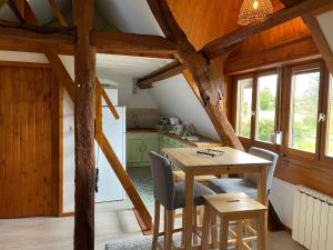 a kitchen and dining room with a table and chairs at L'atypique au pays de Honfleur in Genneville