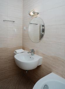 a bathroom with a white sink and a mirror at Hotel Resident in Nowa Sarzyna