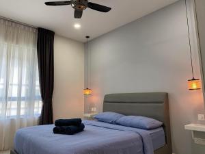 a bedroom with a bed with a ceiling fan at Suasana JB at JB Center Luxury Modern & Rustic 1BR Apt for Bussiness,Vacation trips in Johor Bahru