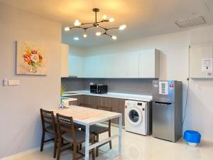 a kitchen with a table and a refrigerator at Suasana JB at JB Center Luxury Modern & Rustic 1BR Apt for Bussiness,Vacation trips in Johor Bahru