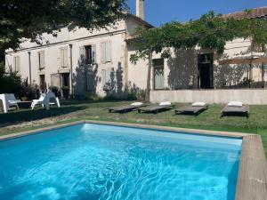 a large swimming pool in front of a house at Mas carita in Cabannes