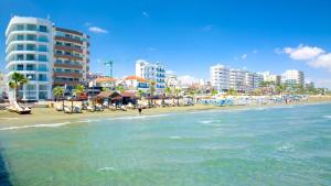 a beach with buildings and the ocean and the ocean at City Flats 308 in Larnaca