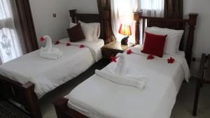 Rúm í herbergi á Al-Minar Hotel