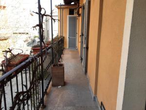 a hallway of a building with a trash can on the sidewalk at Corte Delle Rose in Voghera