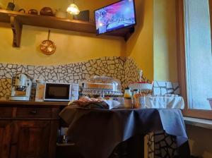 a kitchen with a table with a table cloth on it at B&b La Fontana Borbone in Lauria Inferiore
