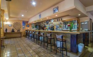 a bar in a restaurant with stools at Hotel Riopar Spa in Riópar