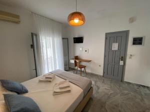 a bedroom with a bed and a table in it at Kostas & Joanna Studios in Logaras