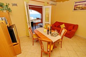 a living room with a table and a couch at Apartments Sea Line in Prigradica