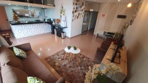 an overhead view of a living room with a couch and a table at Hotel Magnólia in São João da Boa Vista +22 photos