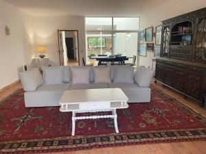 a living room with a couch and a coffee table at Casa da Ermida in Budens