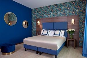 Hotel Spigamonti tesisinde bir odada yatak veya yataklar