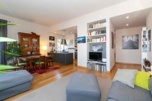a living room with a couch and a dining room at Charming apartment with parking! in Turin
