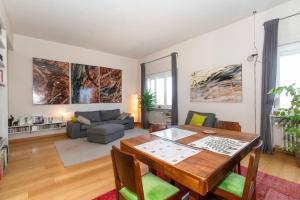 a living room with a table and a couch at Charming apartment with parking! in Turin