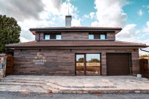 a house with a garage in front of it at Hotel Hunters House in Ezerets
