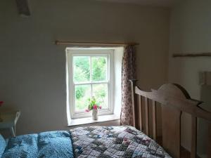 Ένα ή περισσότερα κρεβάτια σε δωμάτιο στο Relaxing 2-Bed Cottage in Rhandirmwyn