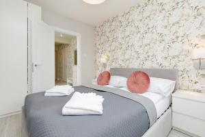 เตียงในห้องที่ Jantar Apartamenty - Porta Mare