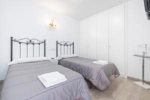 two beds sitting next to each other in a room at Bacana 3-3 Apartment Levante Beach in Benidorm