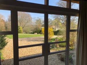 a view through a window of a yard at The Barn in Romsey