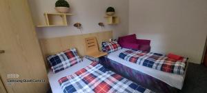 a bedroom with two twin beds in a room at Penzion Svojanov in Svojanov