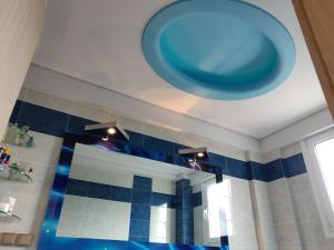 a large blue bowl on the ceiling of a bathroom at Dimitris Vaso’s Villa with Sea and Mountain View! in Aliveri