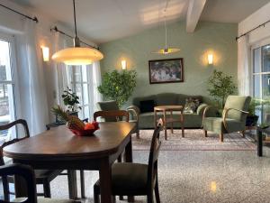 a living room with a table and a couch at Austragshaus Almbranz in Helmbrechts