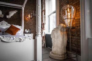 a bedroom with a bed and a lamp in a room at The Auction House in Morpeth