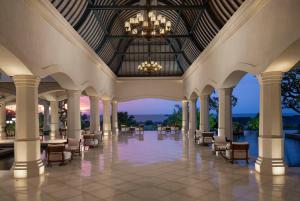 a large lobby with chairs and a chandelier at Jumeirah Bali in Uluwatu