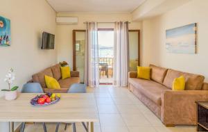 a living room with a couch and a table at Aloustina Apartments in Archangelos