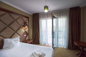 Postel nebo postele na pokoji v ubytování HOTEL ADRIANO