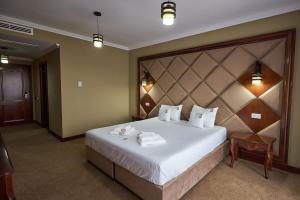 Postel nebo postele na pokoji v ubytování HOTEL ADRIANO