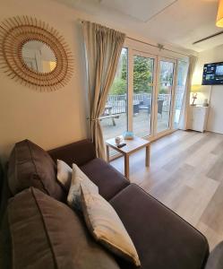a living room with a couch and a table at 147 Snowdon Drive, Glan Gwna in Caernarfon
