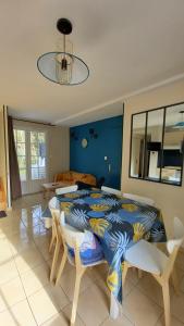 a bedroom with a bed and a table and chairs at Villa L'Acacias in Longeville-sur-Mer