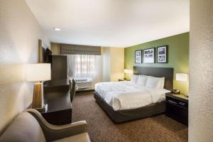 a hotel room with a bed and a window at Sleep Inn West Valley City - Salt Lake City South in West Valley City