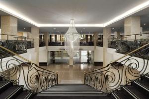 Una escalera en un edificio con una lámpara de araña. en The Victoria Hotel, en Melbourne