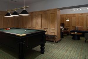 a pool table in a room with wood paneling at The Victoria Hotel in Melbourne