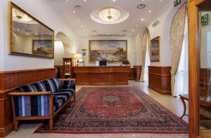 a court room with a bench and a reception desk at Hotel Raffaello - Sure Hotel Collection by Best Western in Rome