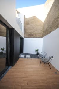 a room with a wooden floor and a table and chairs at Aljube Residences I - Apt novo, com terraço, centro PDL in Ponta Delgada