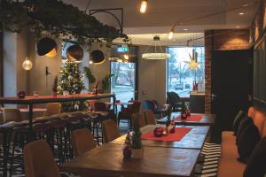 a restaurant with tables and chairs and a christmas tree at Hotel Fredrikstad in Fredrikstad