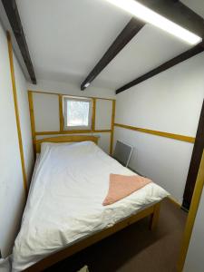 a bed in a small room with a window at Hotel Mlyn in Nikolayev