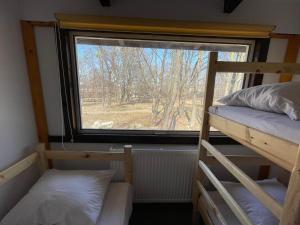 a small room with two bunk beds and a window at Hotel Mlyn in Nikolayev