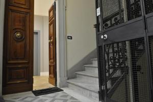 a hallway with a door and stairs with a gate at Carrara 24 in Rome