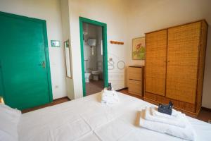 a bedroom with a bed with two towels on it at Residenza Crivo in Parghelia