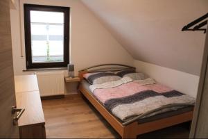 a bedroom with two beds and a window at Haus Herrloch in Hermeskeil
