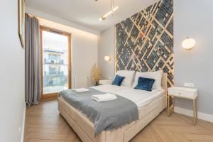 Posteľ alebo postele v izbe v ubytovaní Pomorskie Apartamenty Bernadowska Gold