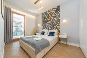 Posteľ alebo postele v izbe v ubytovaní Pomorskie Apartamenty Bernadowska Gold