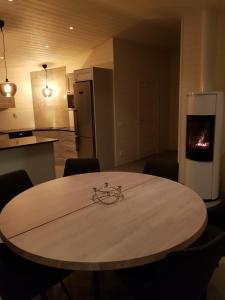 cocina con mesa y cocina con nevera en Stuga (Cottage) ålaryd en Skillingaryd